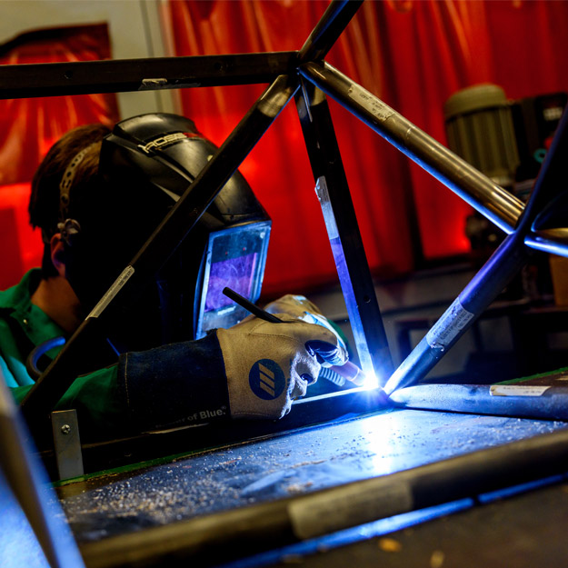 A student wearing googles looks into a scope in the BIC.
