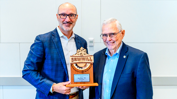 Alumnus Joe Ritz holding 2026 Tom Mason Innovation Award trophy during Sawmill Society Weekend with Tom Mason