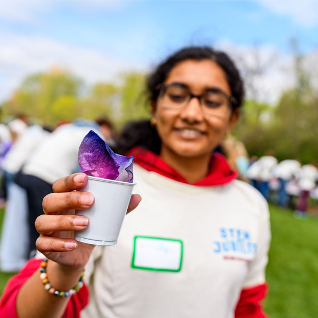 A child plays with slime during a science experiement.