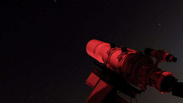A telescope points toward the night sky.