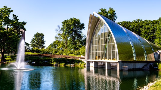 Exterior view of White Chapel with blue sky and Speed Lake.